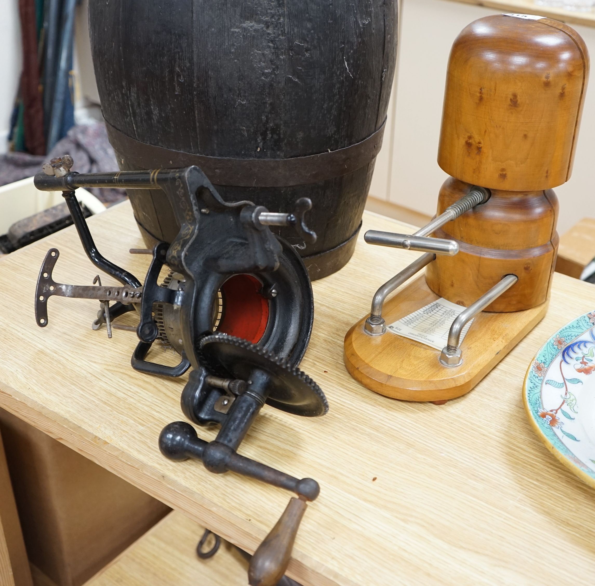 A wooden hat stretcher, 35cms high and a sock making machine